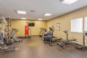 a gym with several treadmills and machines in a room at Captain's Quarters Riverfront #1 in Nashville