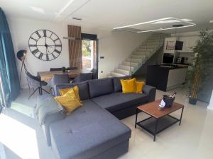 a living room with a couch and a table at Golden residence with heated pool in Vinišće