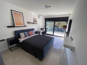 a bedroom with a bed and a desk and a window at Golden residence with heated pool in Vinišće +24 photos