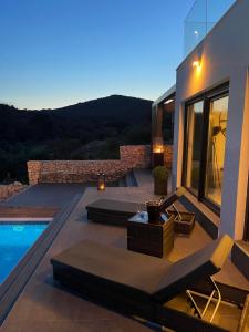 a villa with a swimming pool and a house at Golden residence with heated pool in Vinišće
