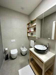 a bathroom with a sink and a toilet at Sapphire Residence Green Coast in Palasë +35 photos