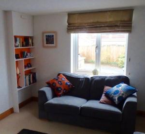 a living room with a couch and a window at The Laurels in Westwood