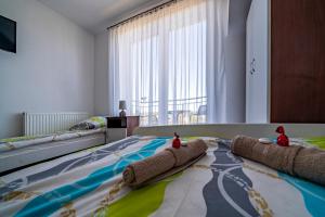a bedroom with a bed with two stuffed animals on it at Pod Jedynkami in Władysławowo