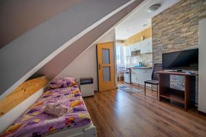 a room with a bed and a living room at Pod Jedynkami in Władysławowo
