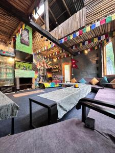 a room with a table and a mural on the wall at Sunshine Cafe & Cottage Riverside in Shoja