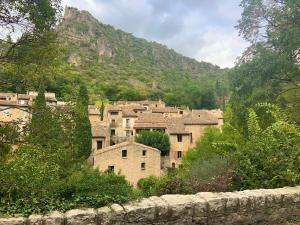 a group of buildings in front of a mountain at La Posada Townhouse with Private Parking in Pézenas