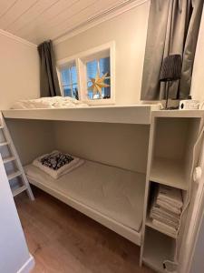 a bedroom with a bunk bed with a window at Ny lägenhet i Vesene in Ljung