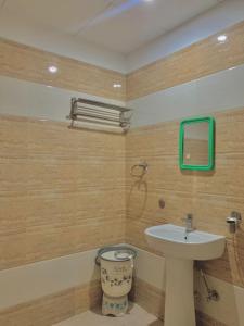 a bathroom with a sink and a toilet at Hotel Sukhman Residency in Amritsar