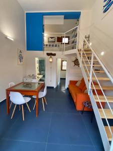 a living room with blue flooring and a staircase at Casa Nadip in Ustica