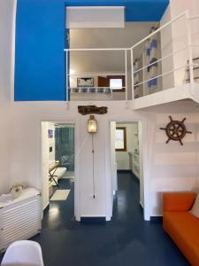 a living room with a staircase and an orange couch at Casa Nadip in Ustica
