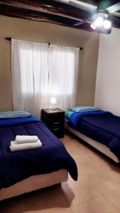 Una cama o camas en una habitación de Departamento en zona Alto Maipú