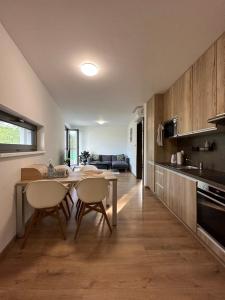een keuken en een woonkamer met een tafel en stoelen bij OTA-Group Luxury selection in Bratislava