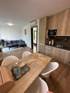 uma cozinha e sala de estar com uma mesa de madeira e cadeiras em OTA-Group Luxury selection em Bratislava
