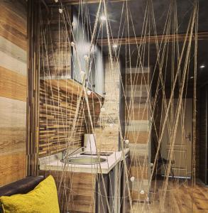 a room with a hanging chair and a table at Apartman OGLEDALO in Zaječar +18 photos