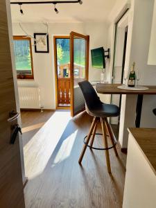 a chair sitting at a table in a kitchen at Studio Rittisberg im Haus Sonnleitner in Ramsau am Dachstein