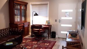 a living room with a desk and a chair at Camden Valley Terrace 4 