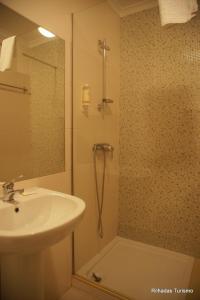 a bathroom with a sink and a shower at Rilhadas Casas de Campo in Fafe