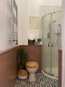 a bathroom with a toilet and a glass shower at Fabulous flat in Durnford Street in Plymouth