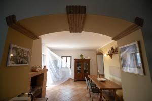 a living room with a table and a dining room at Locanda Adriana in Montefranco