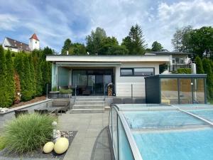 a home with a swimming pool and a house at Mostviertel Lodge in Ardagger Markt
