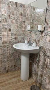 a bathroom with a white sink and a mirror at Lazzarella in Naples