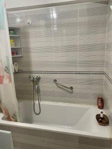 a bathroom with a bath tub with a shower at STAR APPARTEMENT GAUTHIER in Casablanca