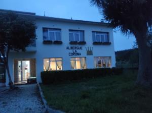 a building with a sign on the side of it at Albergue La Corona1 in O Pino  +10 photos