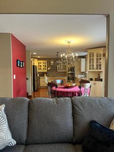 a living room and kitchen with a couch and a table at Hotel/Home in Windsor