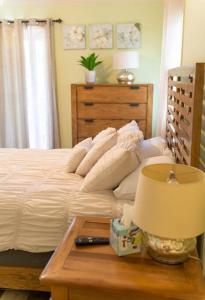 a bedroom with a bed and a table with a lamp at North Ocean city newly Remodeled in Ocean City