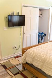 a bedroom with a bed and a flat screen tv on the wall at North Ocean city newly Remodeled in Ocean City