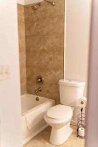 a bathroom with a white toilet and a bath tub at North Ocean city newly Remodeled in Ocean City