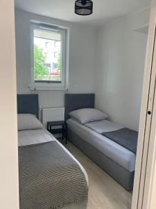 Posteľ alebo postele v izbe v ubytovaní Apartament MORENA