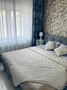 a bedroom with a large bed and a window at Villa Schönfeld in Schönfeld