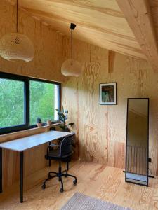 a home office with a desk and a mirror at Domek na wzgórzu 