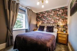 a bedroom with a bed and a window at 1863 Restaurant with Rooms in Pooley Bridge