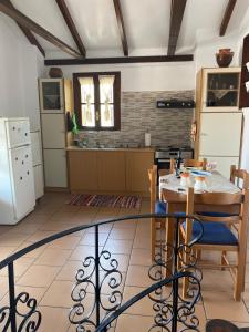 a kitchen with a table and chairs in a room at Evgenia's Guest House in Neo Itilo
