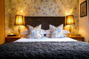 1 dormitorio con 1 cama grande y 2 lámparas en 1863 Restaurant with Rooms en Pooley Bridge