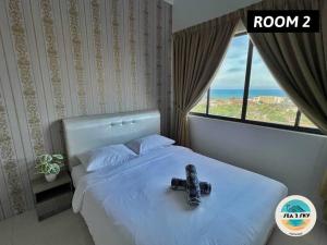 a bedroom with a bed with a camera on it at Sky2Sea Penthouse @ Icon Residences in Kuala Terengganu