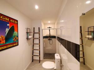 uma casa de banho com um WC e uma escada para um chuveiro em LA CLOSERIE DE NOINTOT em Nointot
