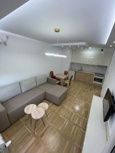 a living room with a couch and a table at Apartman Mina in Požarevac