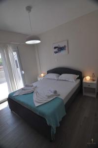 a bedroom with a large bed with a window at Zennova #24, FLOW Nikiti Family Apt in Nikiti