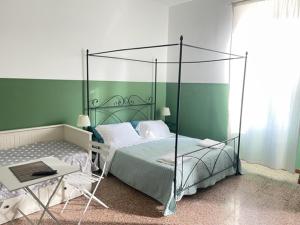 a bedroom with a canopy bed and a table at casa san Pietro in Rome