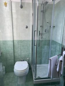 a bathroom with a toilet and a glass shower at casa san Pietro in Rome