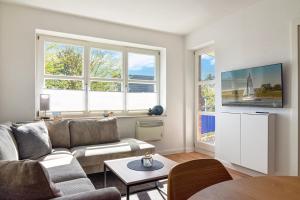 a living room with a couch and a table at Baltic Suite 16 in Stakendorfer Strand