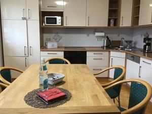a kitchen with a wooden table with a red purse on it at Ferienwohnung Volgenandt Wingerode in Wingerode