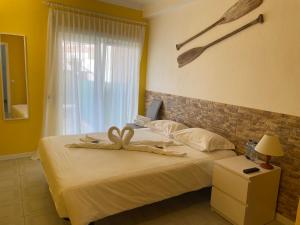 a bedroom with a bed with a bow on it at Stella di Mare - Alojamento Local in Figueira da Foz