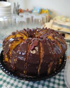 a chocolate cake sitting on top of a table at Shellter Hotel in Holambra