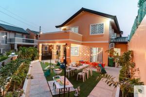 a house with a patio with tables and chairs at DGM AirBnB Urdaneta Pangasinan 
