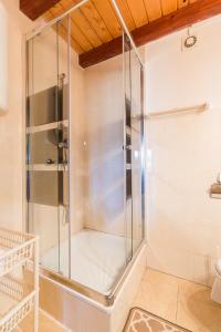 a glass shower in a bathroom with a toilet at Domek Bogdanka in Polańczyk