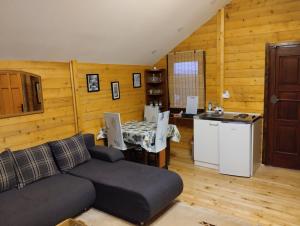 a living room with a couch and a table and a kitchen at TRI KOLIBE in Bor +9 photos